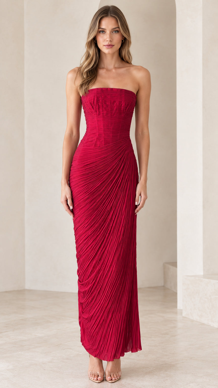 Front view of model wearing strapless red ruched corset column maxi dress