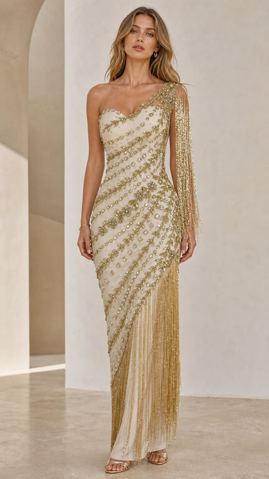 Front view of model wearing champagne one-shoulder beaded fringe gown