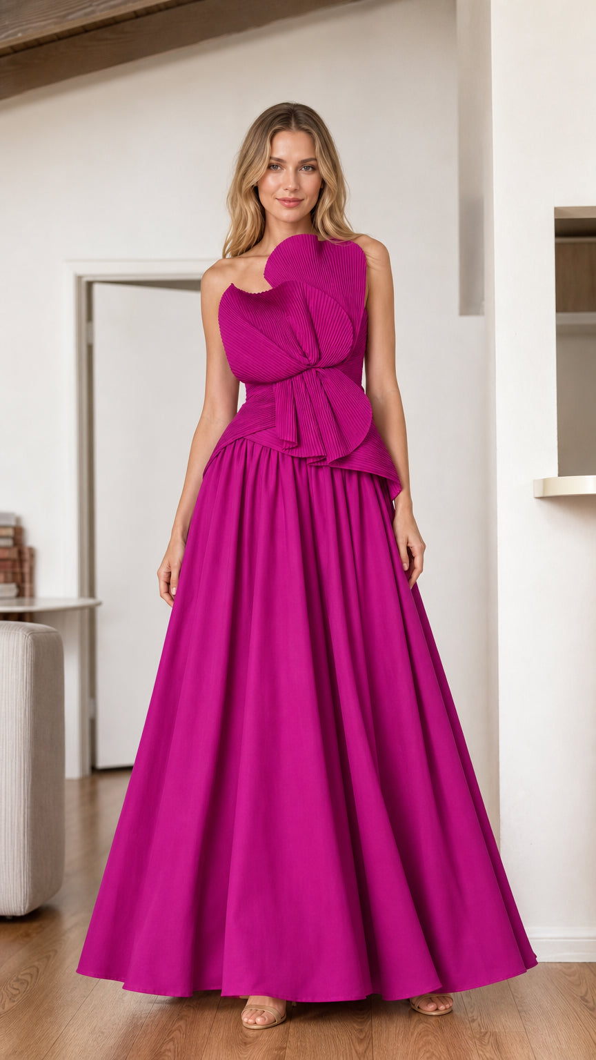 Model wearing a magenta strapless evening gown with sculptural pleated bow bodice - front view