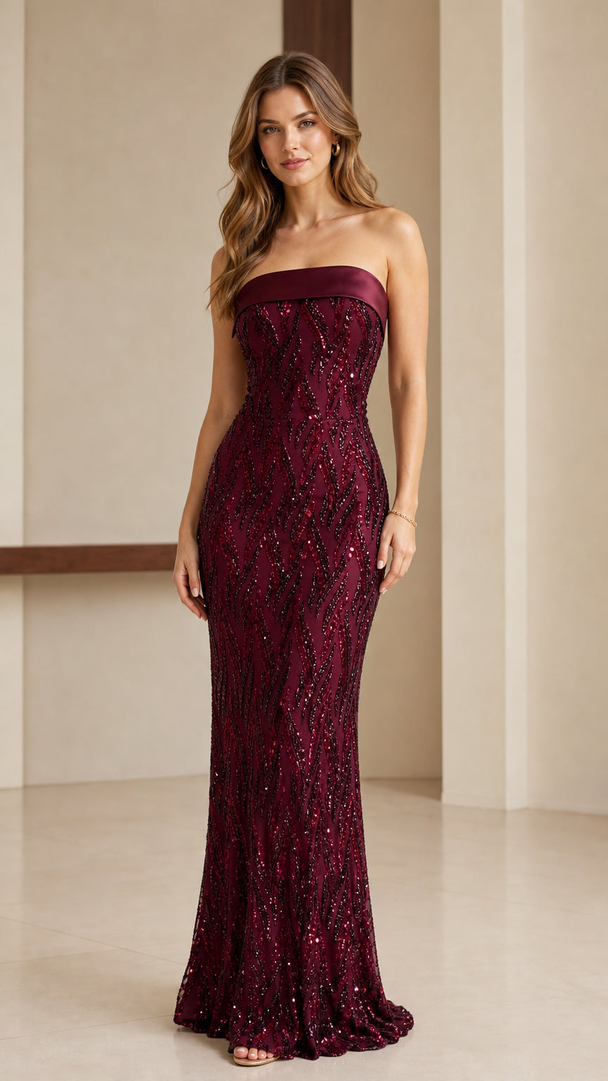 Full-length front view of strapless burgundy sequin evening gown with folded satin neckline