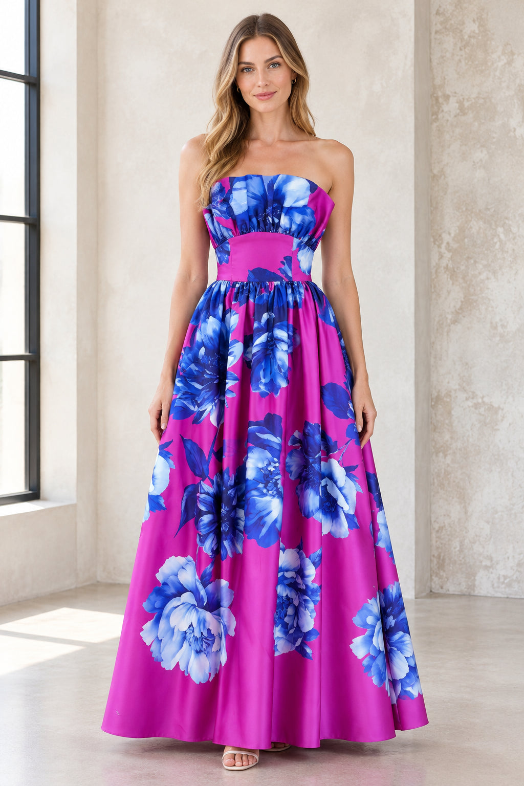 Front view of model wearing magenta strapless floral satin maxi evening dress