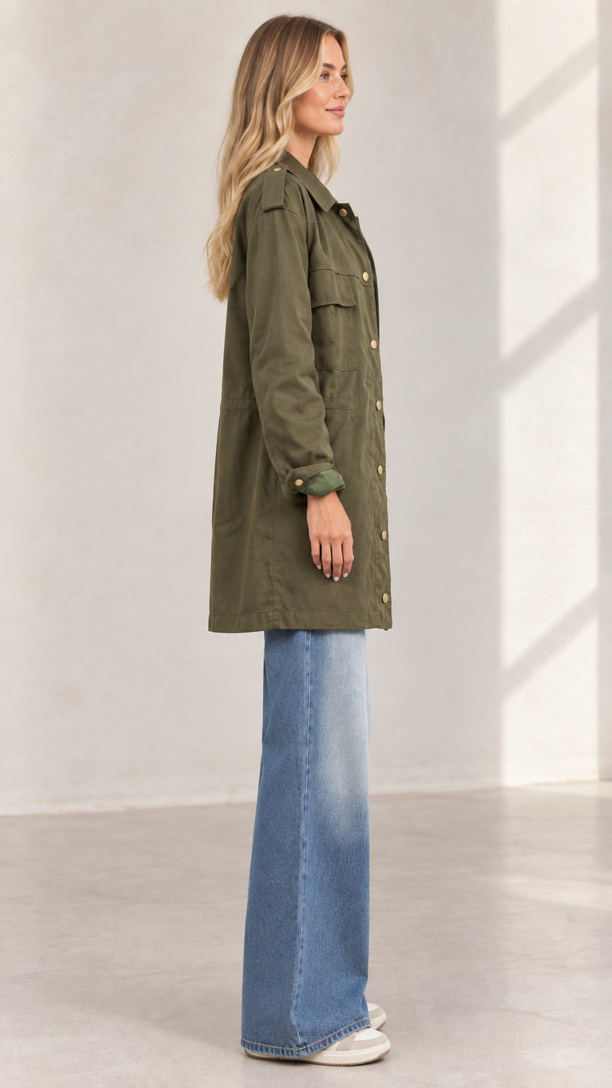 Side profile view of women's army green mid-length utility coat
