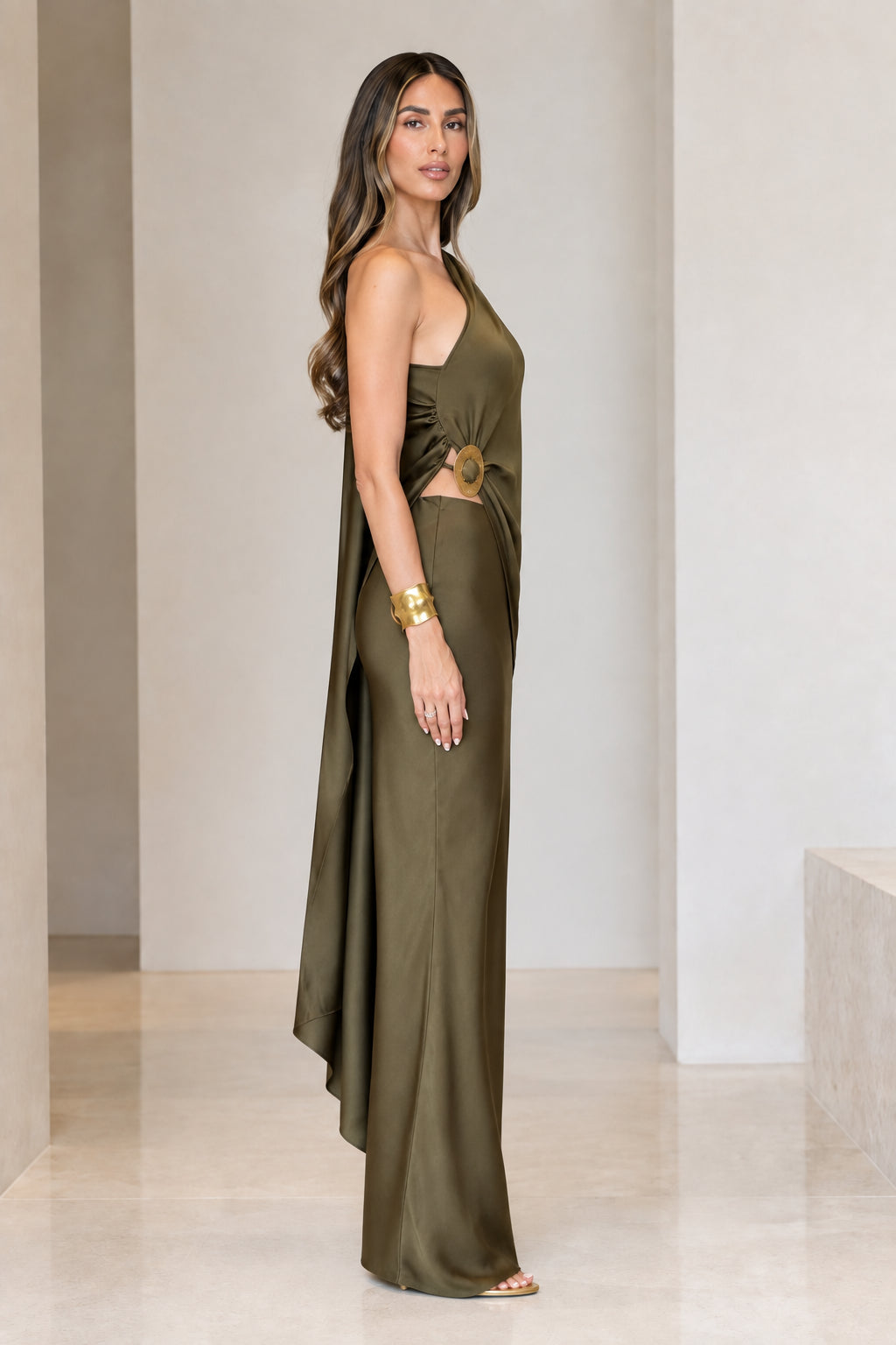 Side view of olive green one-shoulder satin evening dress showing side cutout and metallic ring