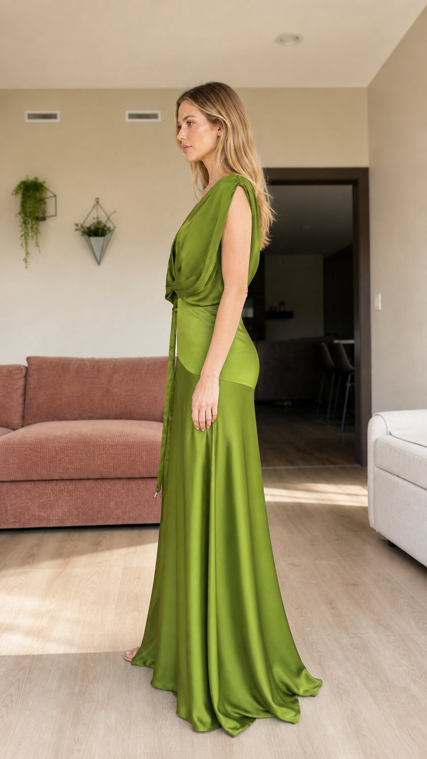 Side view of woman posing in olive green sleeveless satin evening gown