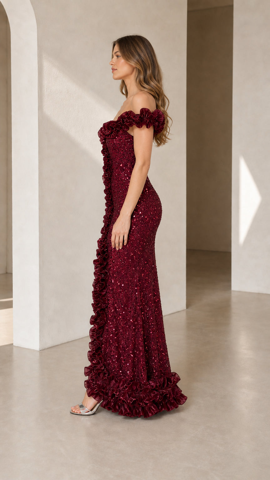 Burgundy sequin mermaid gown with ruffled front slit side view