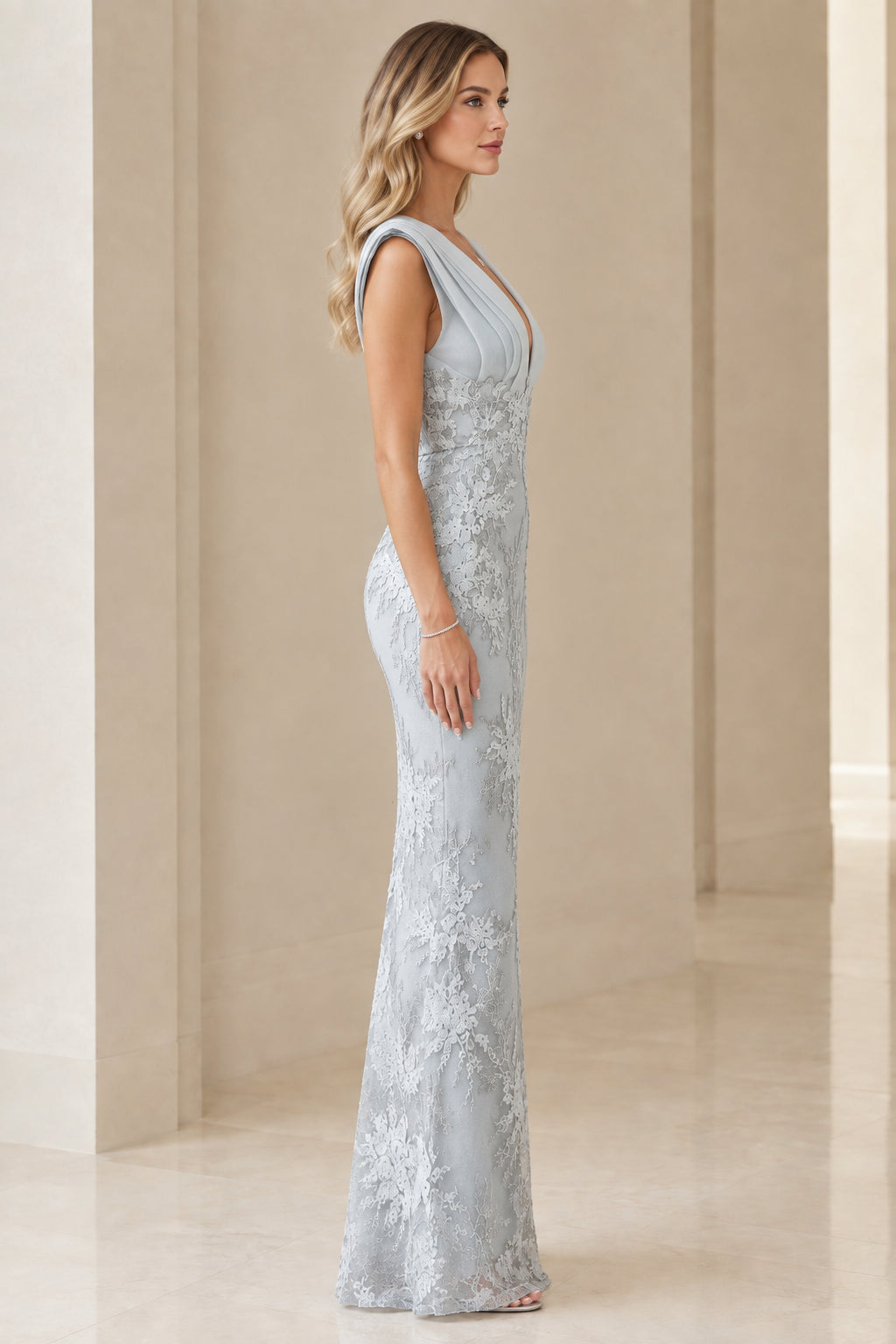 Side profile of model wearing dusty blue corded lace formal column gown