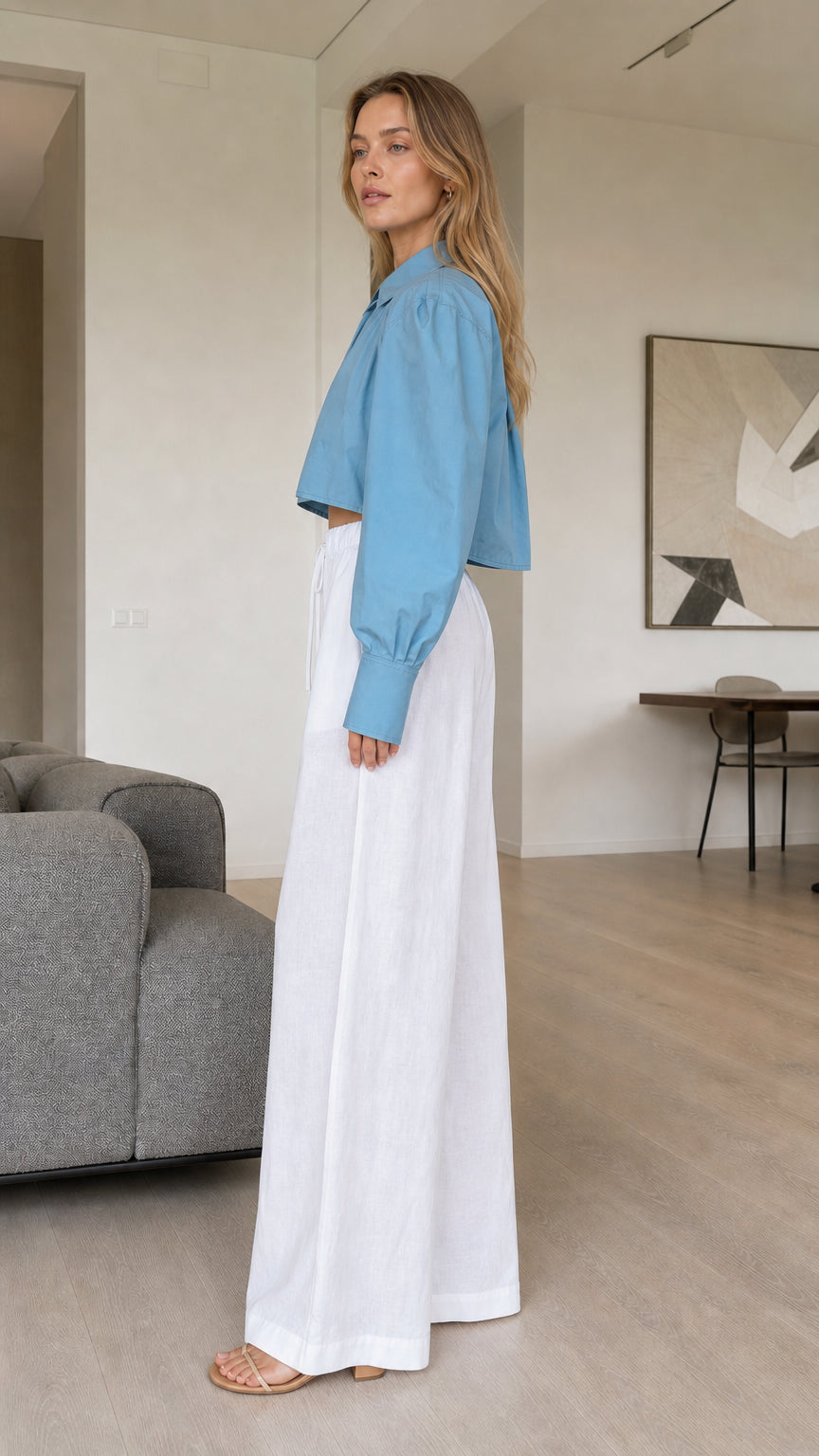 Side profile of dusty blue cropped long sleeve blouse