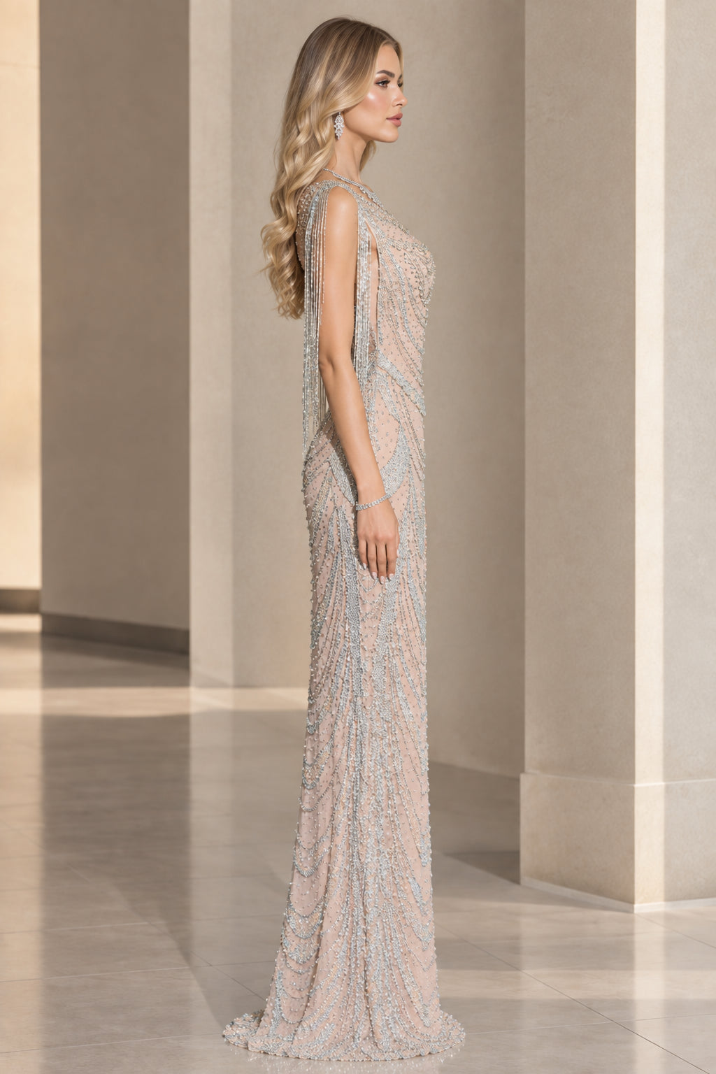Side profile view of champagne beaded formal dress showcasing shoulder fringe