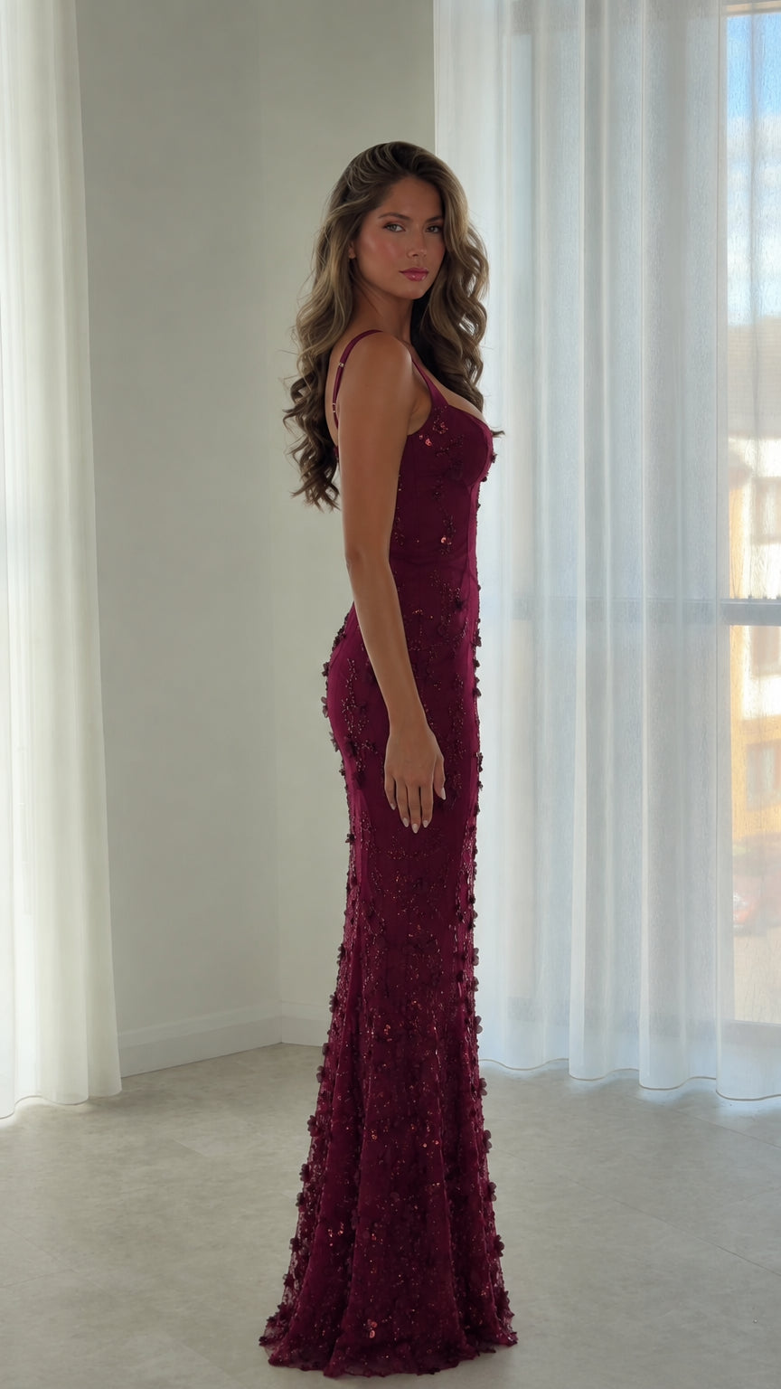 Side profile of model in burgundy embroidered sequin formal maxi dress