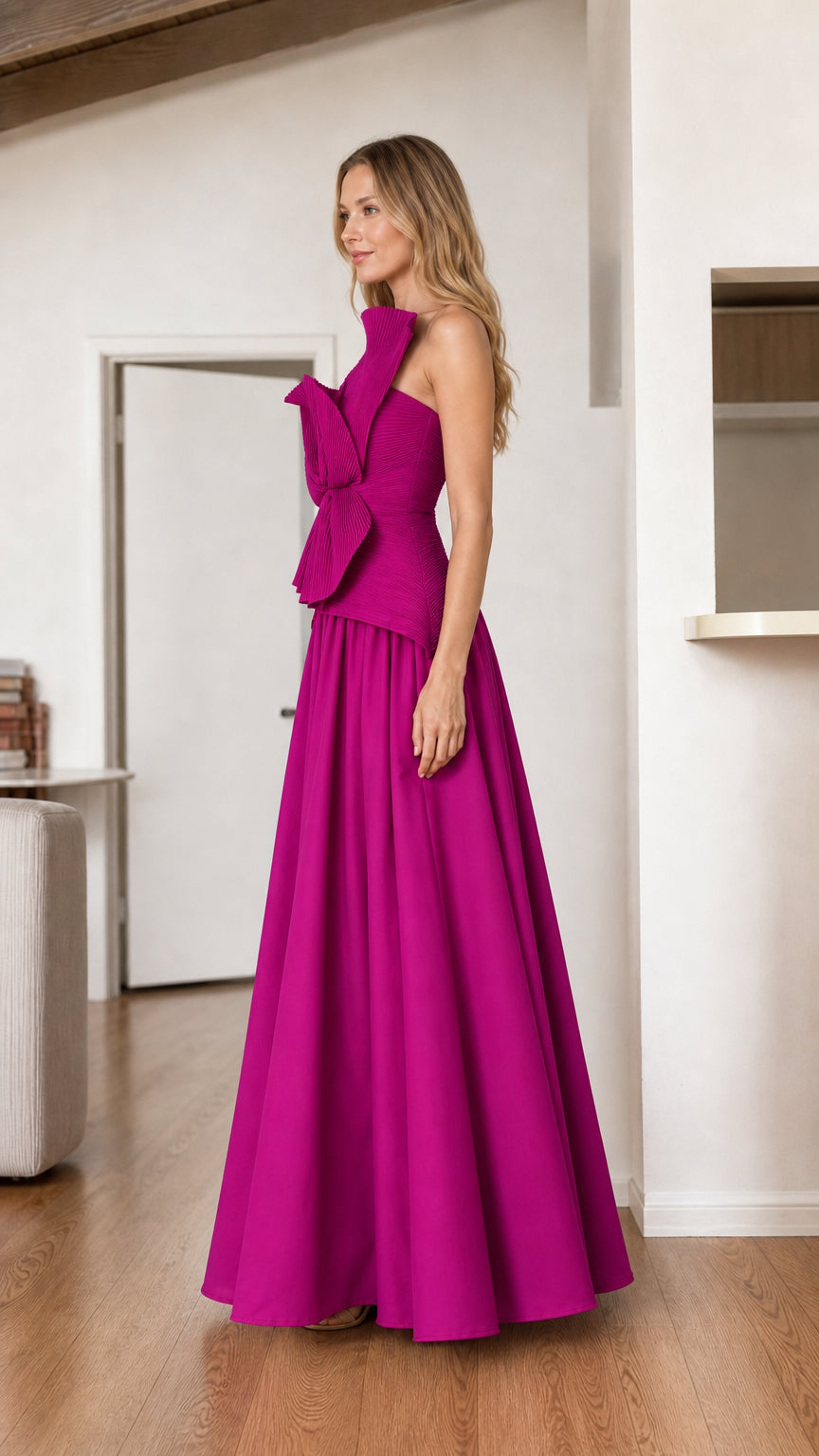 Model posing in a magenta strapless formal maxi dress with side profile view
