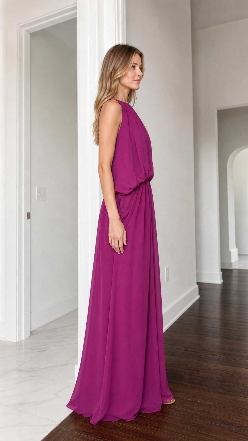 Side view of woman in flowing magenta floor-length evening dress