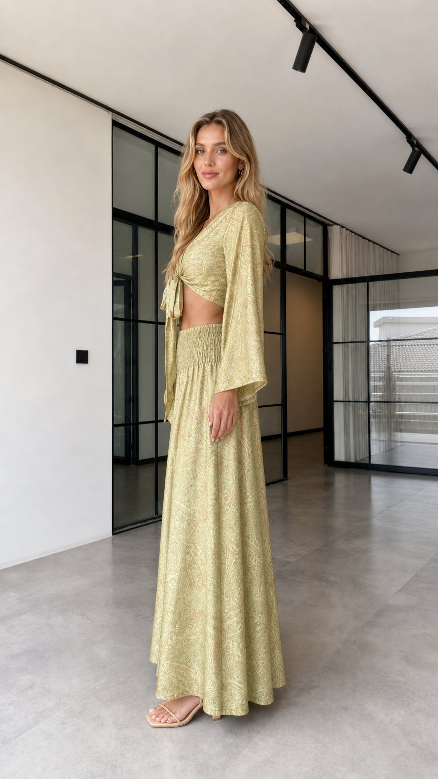 Side view of the olive gold two-piece crop top and flowing wide-leg pants outfit