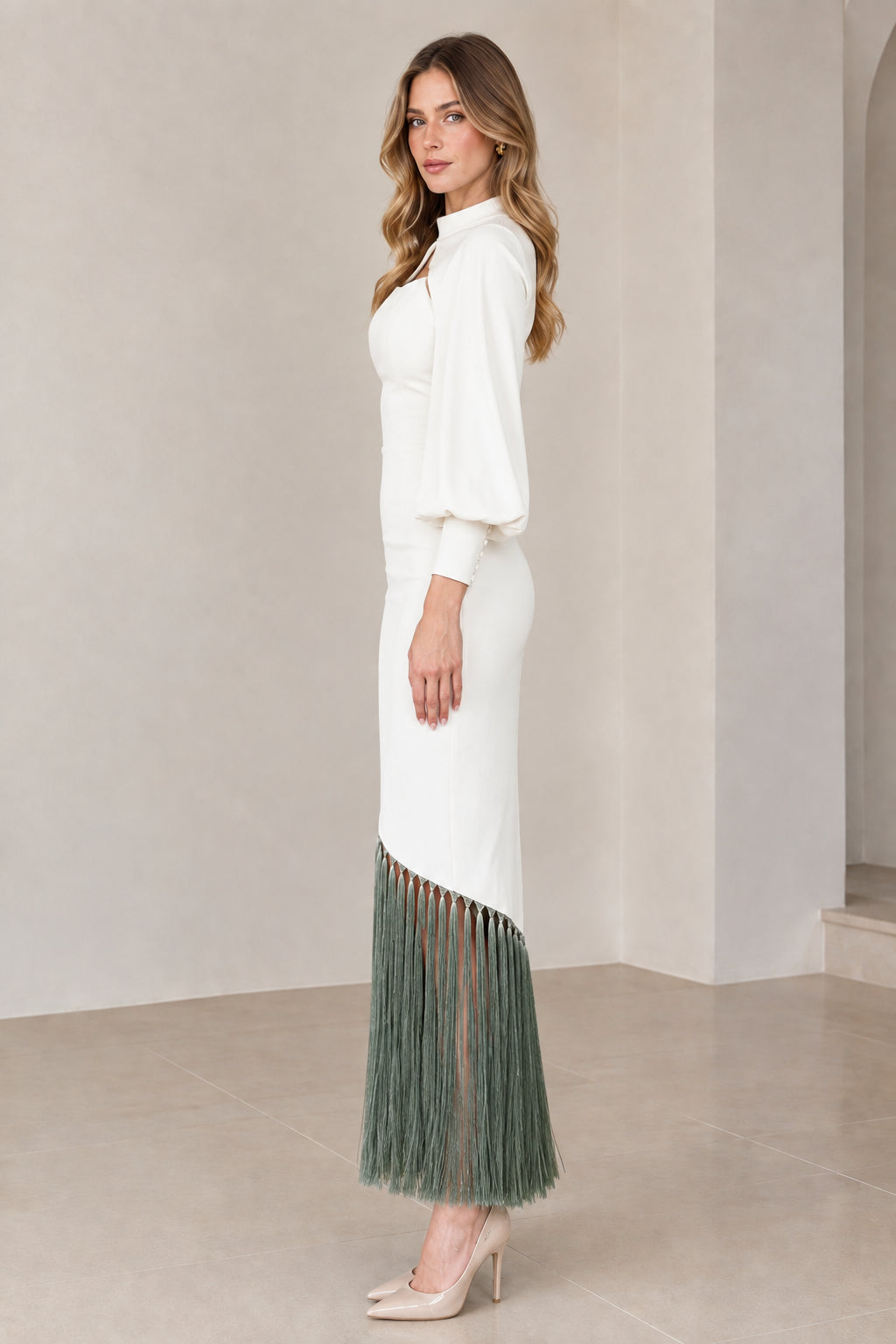 Side profile of white and sage green cape sleeve fringe hem midi dress