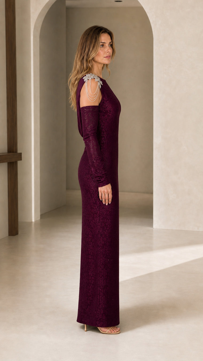 Side profile view of burgundy formal maxi dress highlighting sleek fit and cutout sleeve detail
