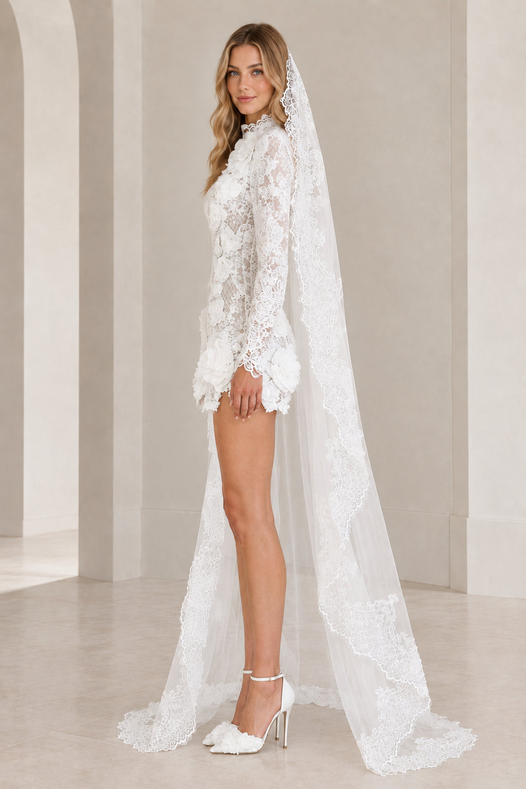 White lace mini dress with 3D floral rosettes and veil cape, side profile view