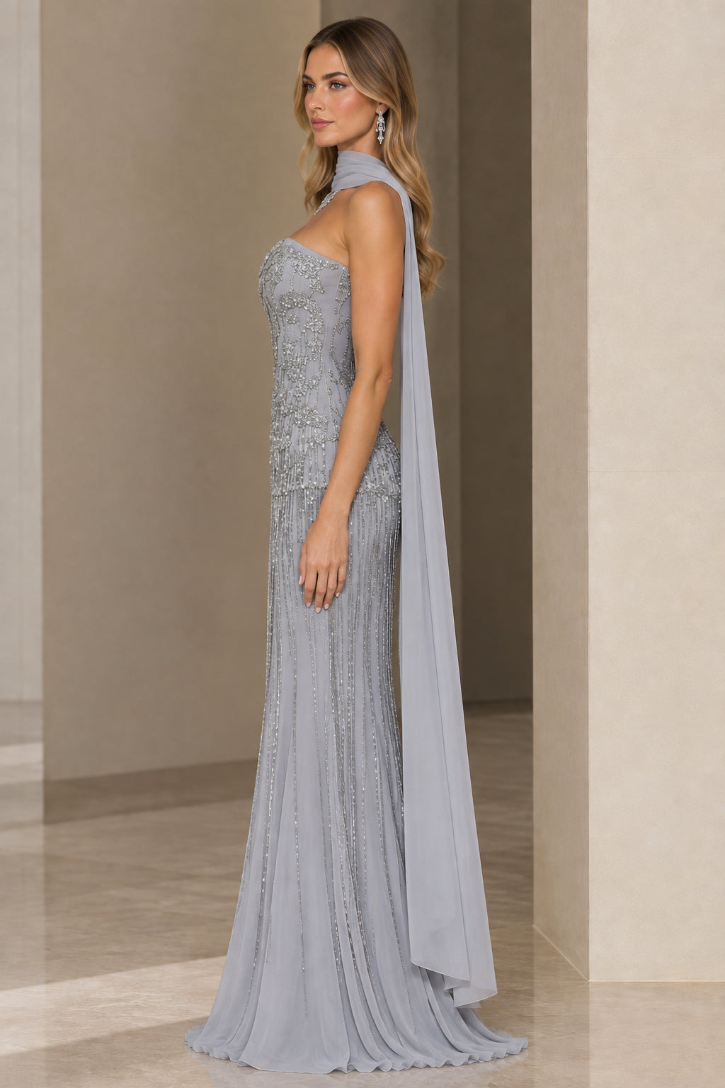 Side view of woman wearing Silver Grey embellished floor-length formal gown with scarf