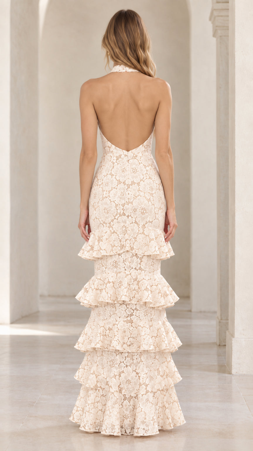 Back view of cream halter lace gown showing deep open back design and tiered skirt
