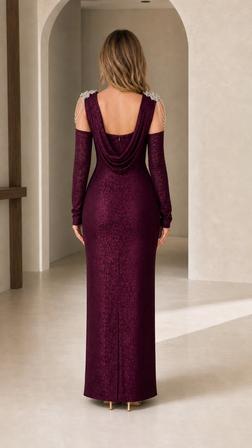 Back view of burgundy evening gown showing open draped cowl back and crystal shoulder chains