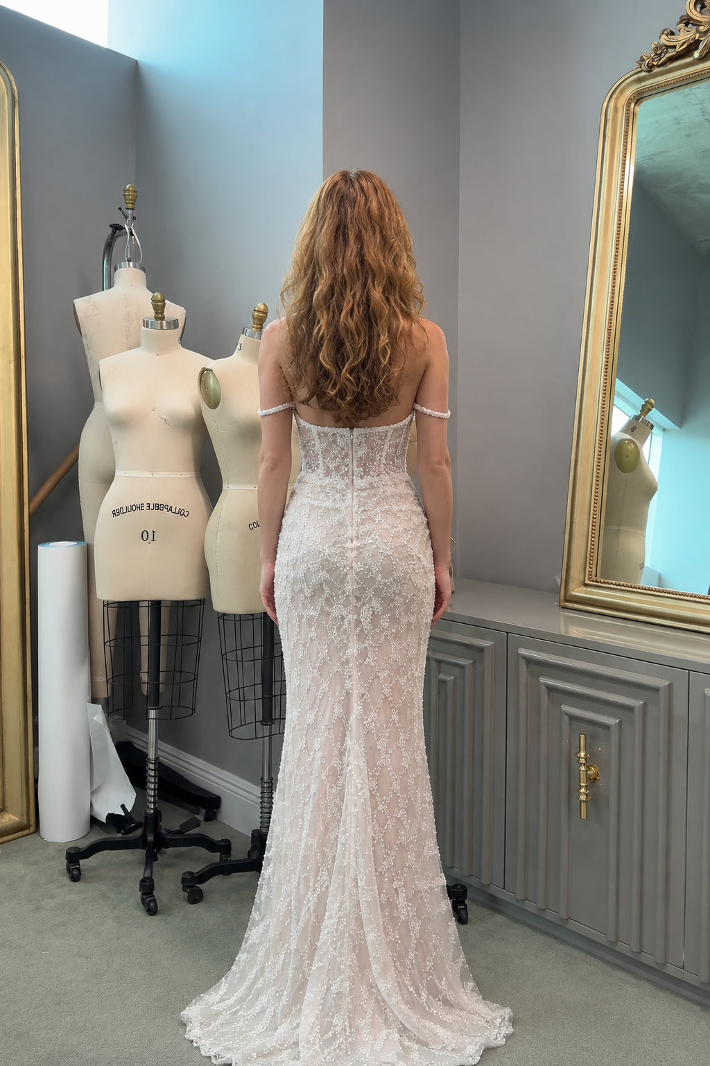 Back view of woman wearing ivory beaded corset mermaid dress showing low back design