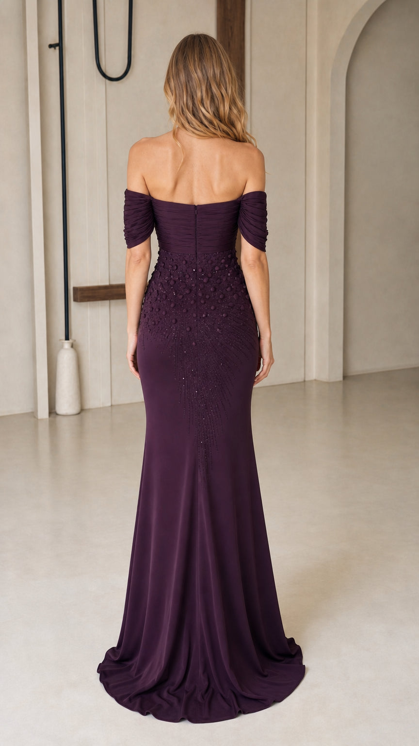 Back view of dark plum off-the-shoulder formal gown showing sweep train