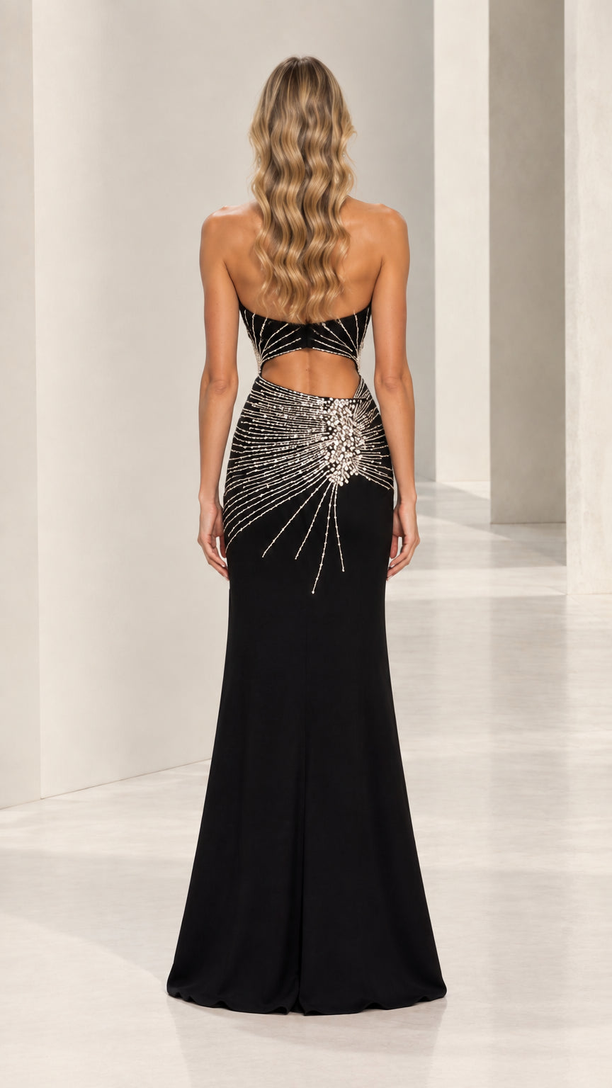 Back view of black halter neck cutout formal gown with open back design