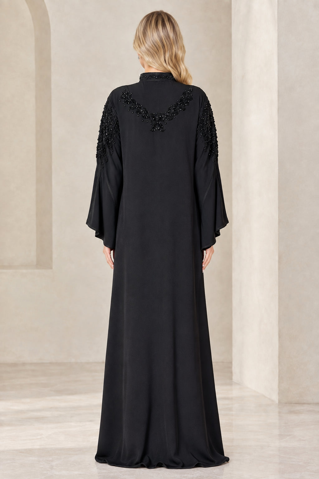 Back view of woman wearing black abaya showing embellished shoulder detail
