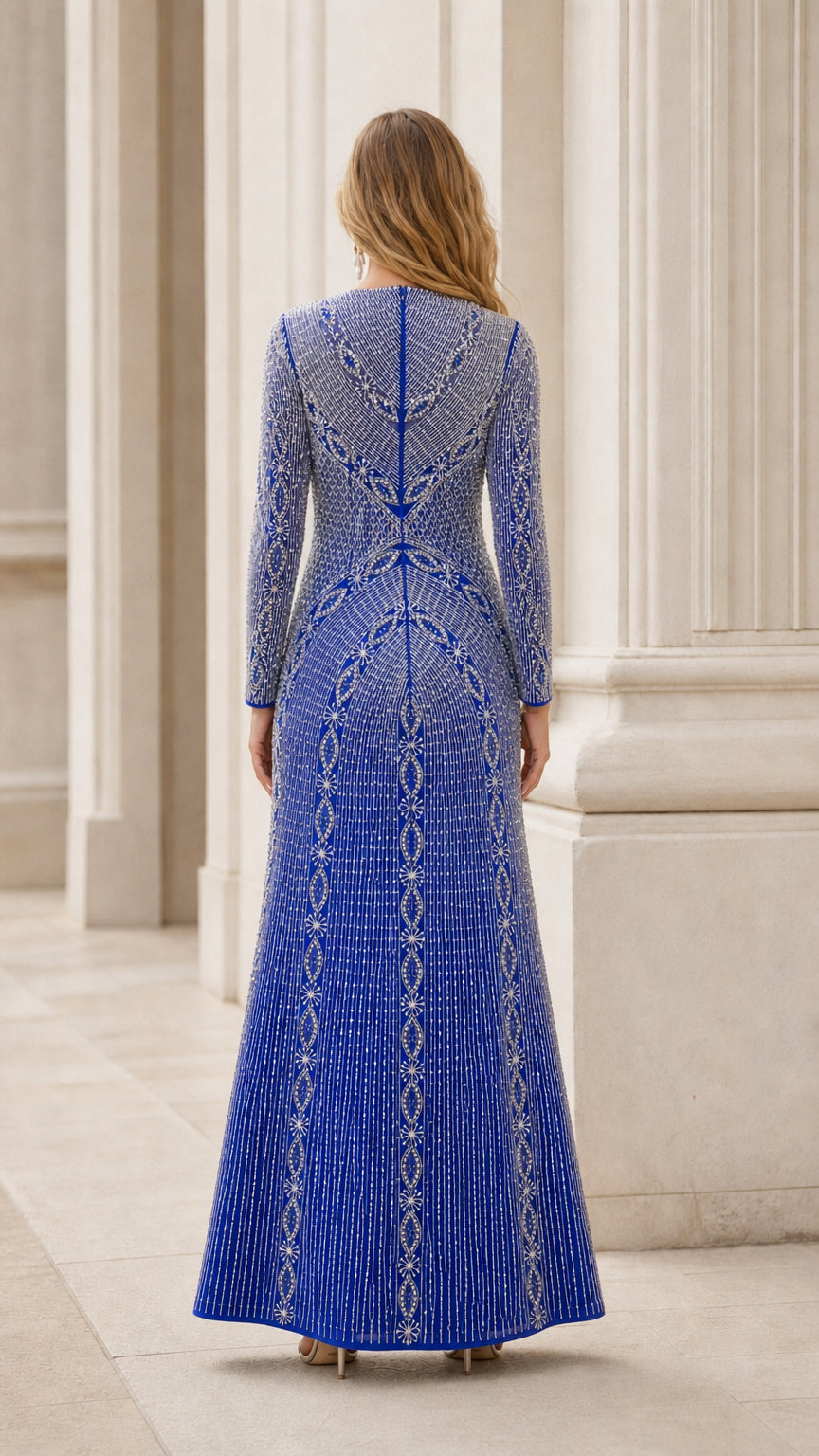 Back view of royal blue long sleeve beaded formal gown with zip closure