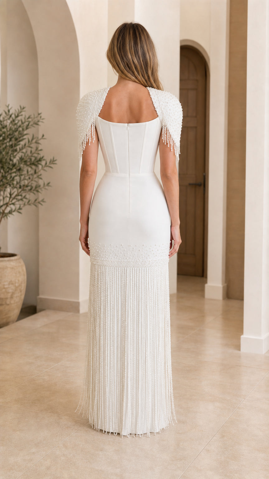 Back view of white corset maxi evening gown with beaded fringe trim