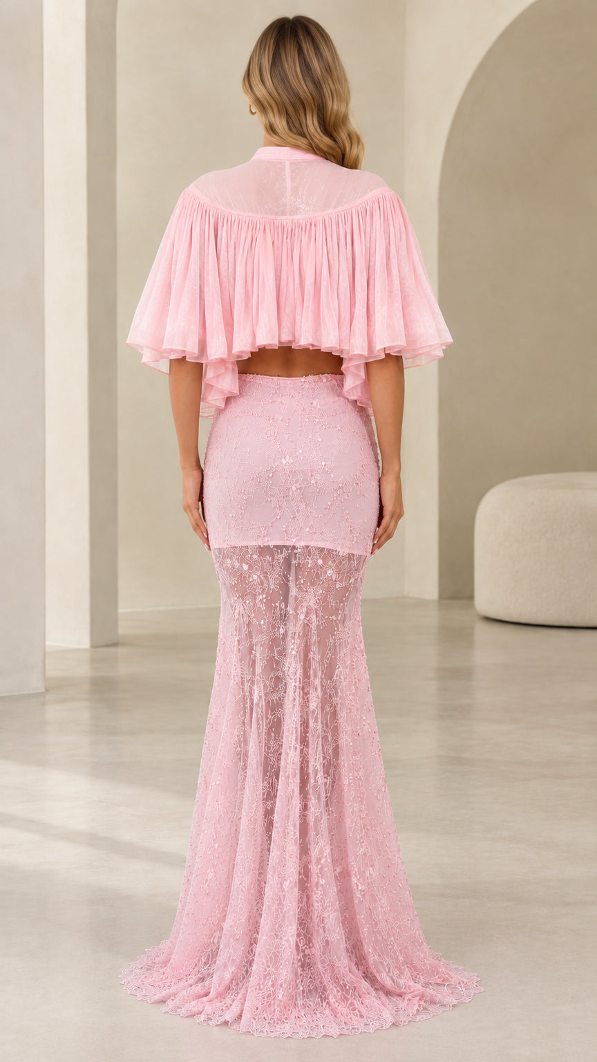 Back view of model wearing pink two-piece evening set with sheer pleated capelet