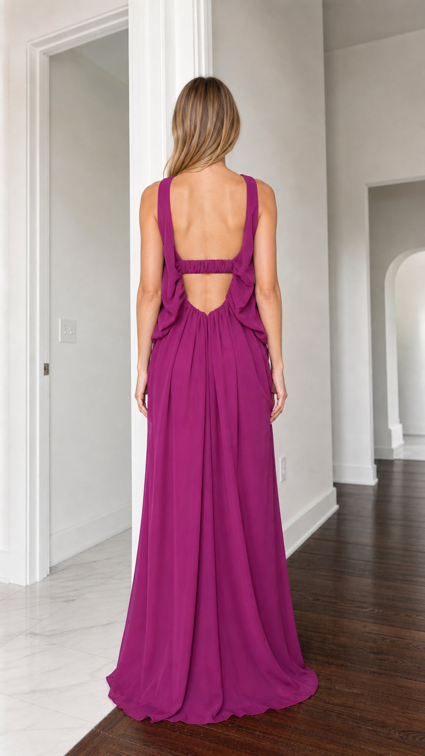Back view of woman showing open back cutout detail of magenta maxi dress