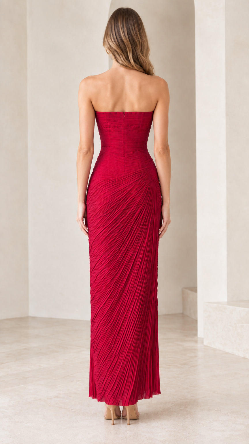 Back view of model wearing red strapless column maxi dress