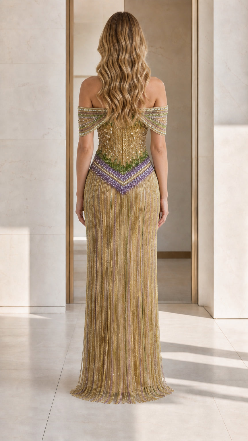 Back view of model showcasing gold beaded gown design