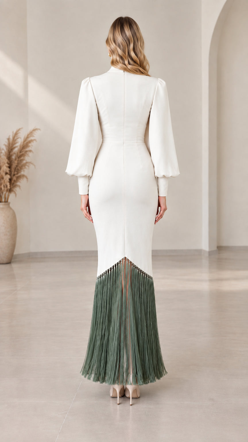 Back view of white long sleeve maxi gown showing tailored fit and fringe hemline