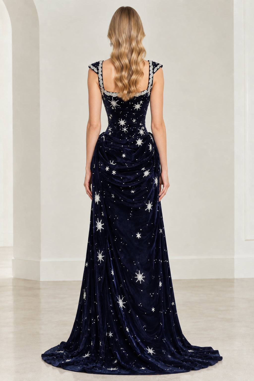 Back view of navy blue velvet evening gown with star embroidery