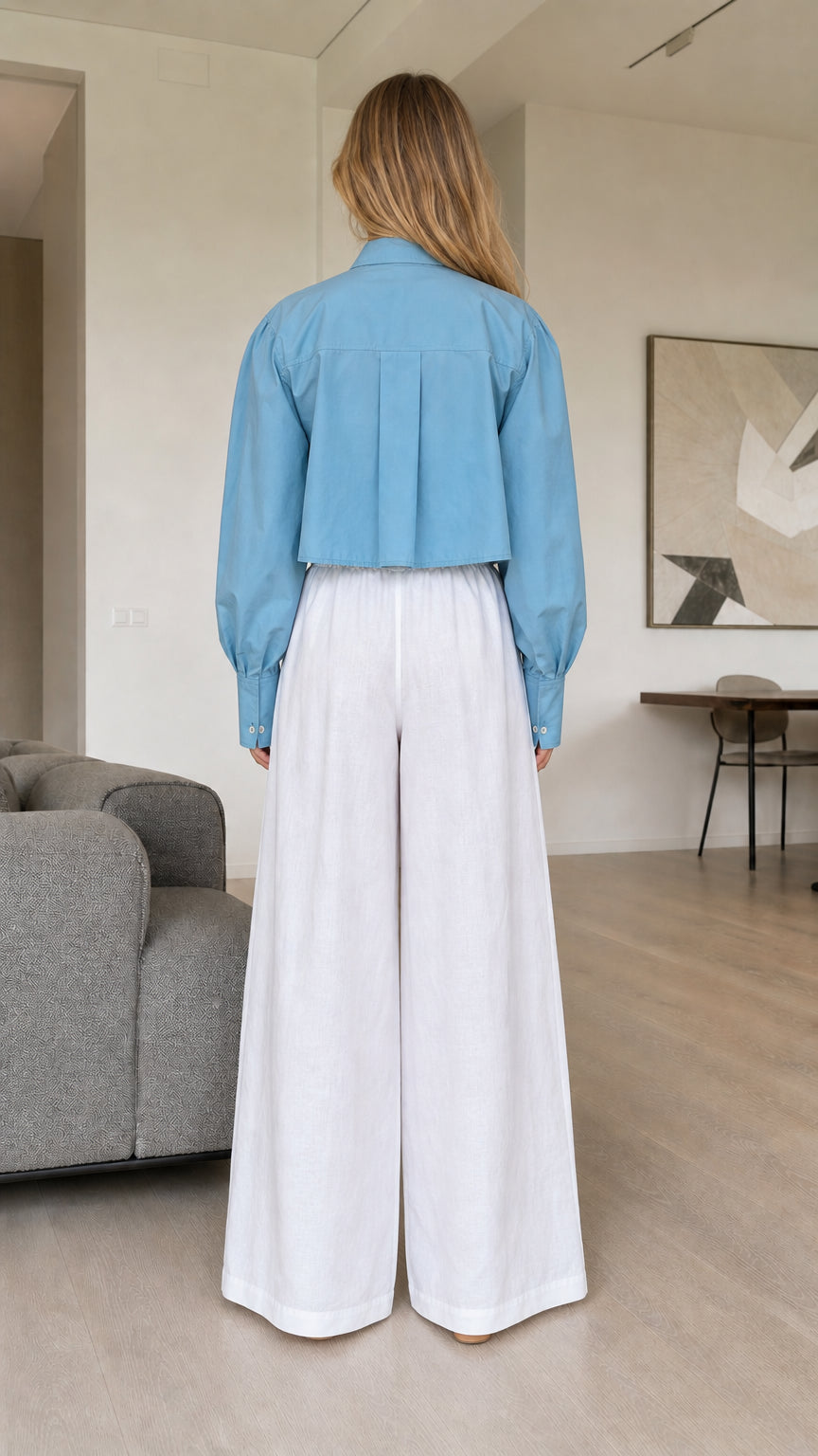 Back view of dusty blue cropped pleated shirt