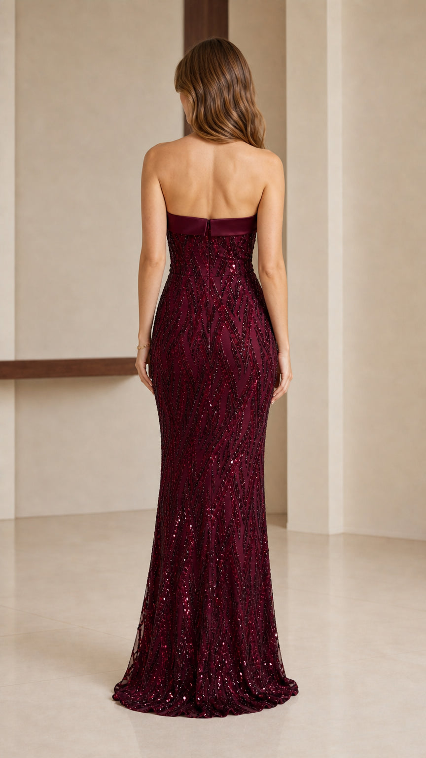 Back view of strapless burgundy sequined maxi column gown