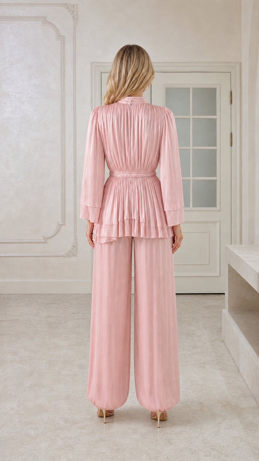Back view of blush pink pleated tunic top and trousers with belted waist