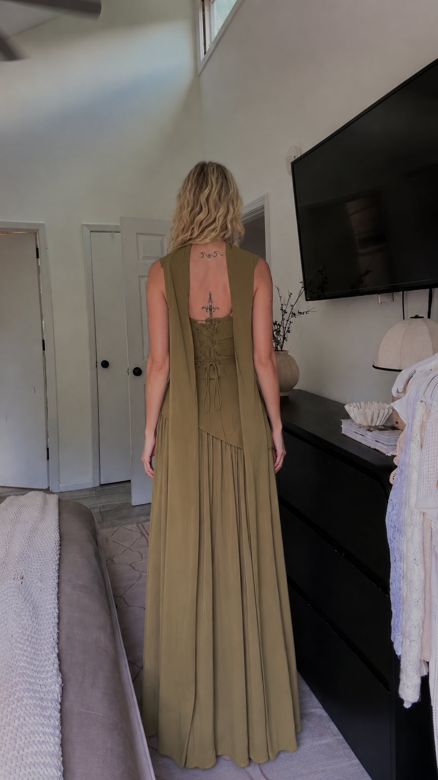 Back view of olive green maxi dress showing lace-up corset back and flowing back drape