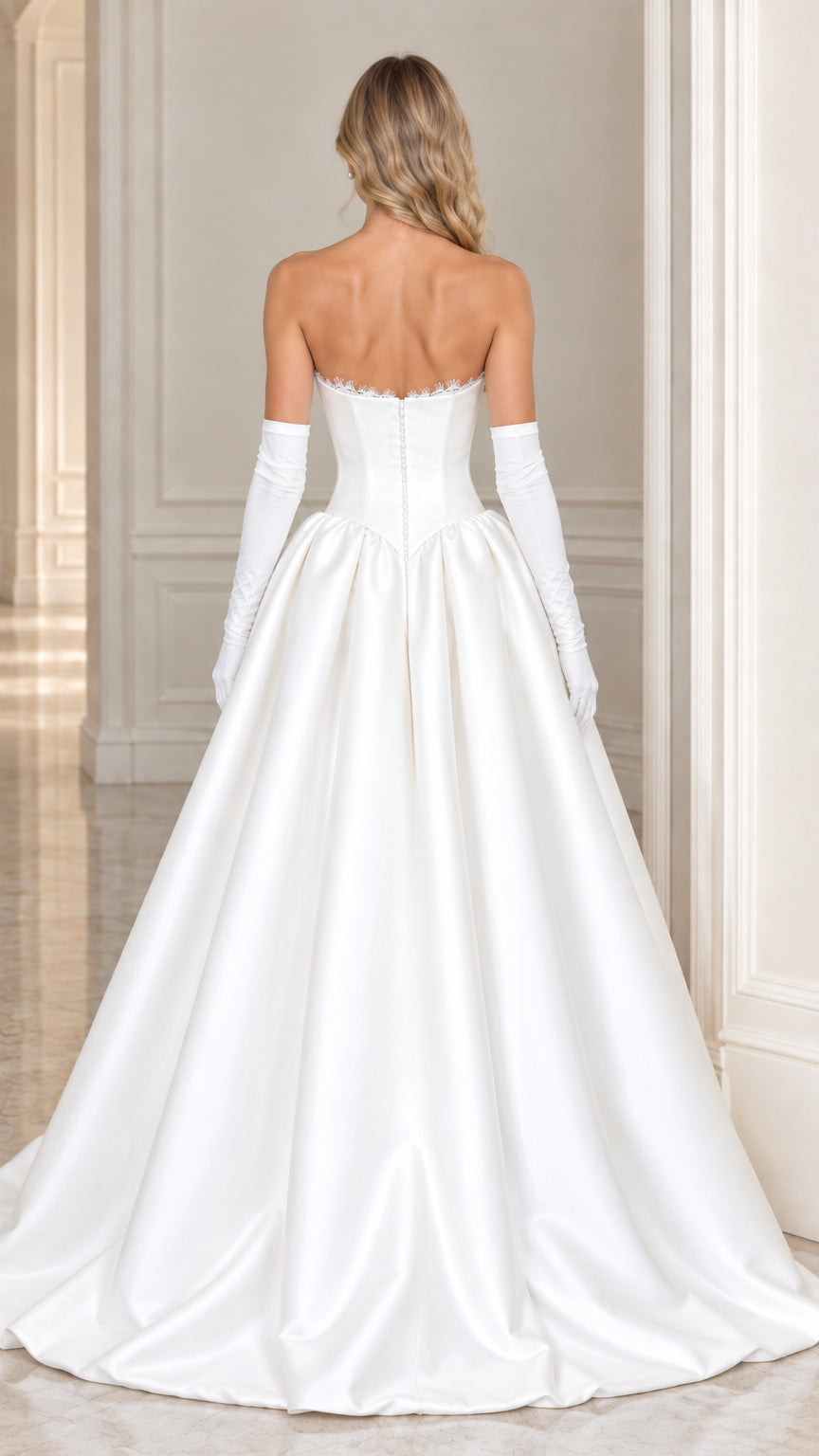 Back view of model in white strapless bridal evening gown showing structured back detail