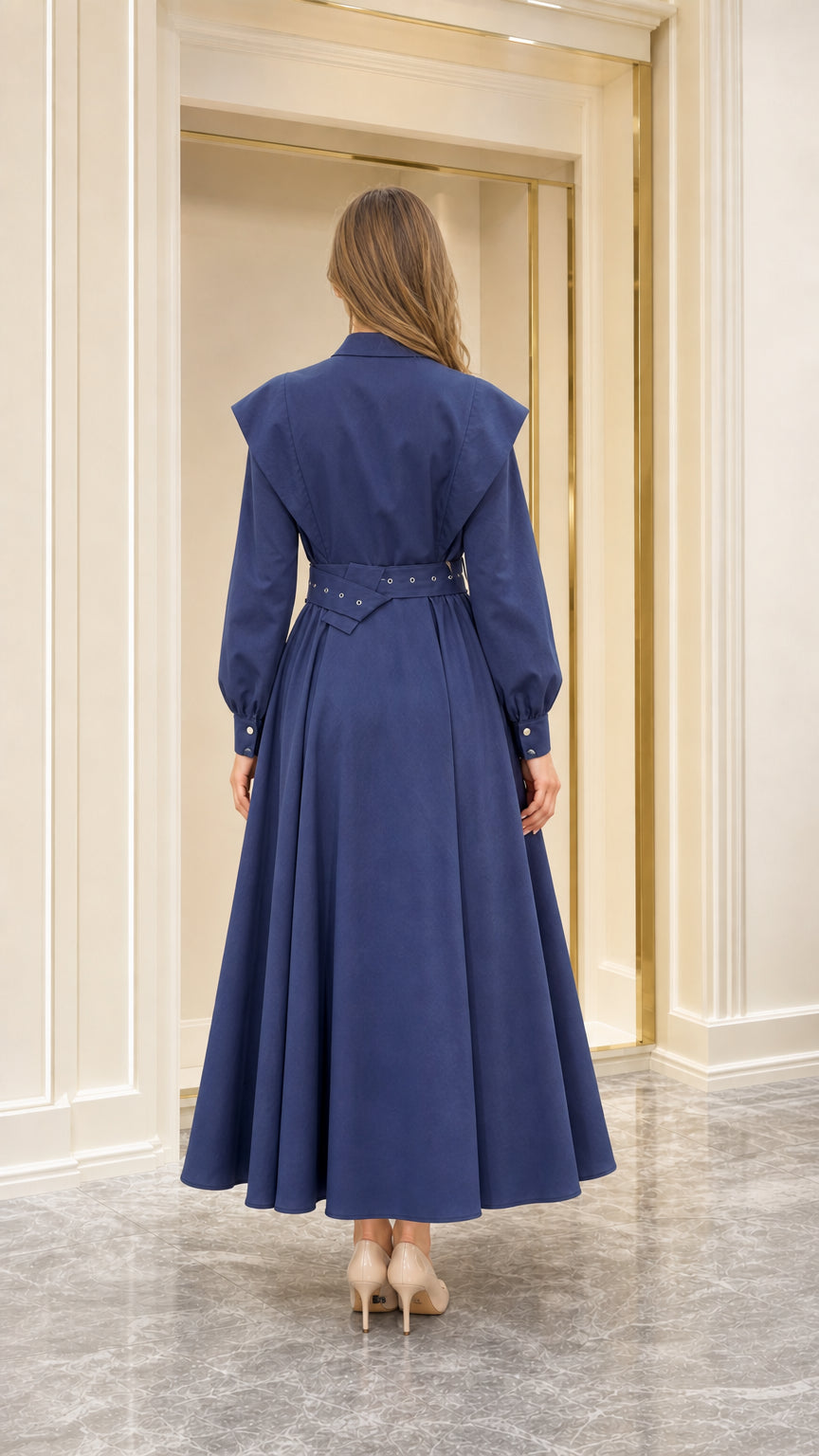 Back view of navy blue belted maxi dress showing cape shoulder overlay