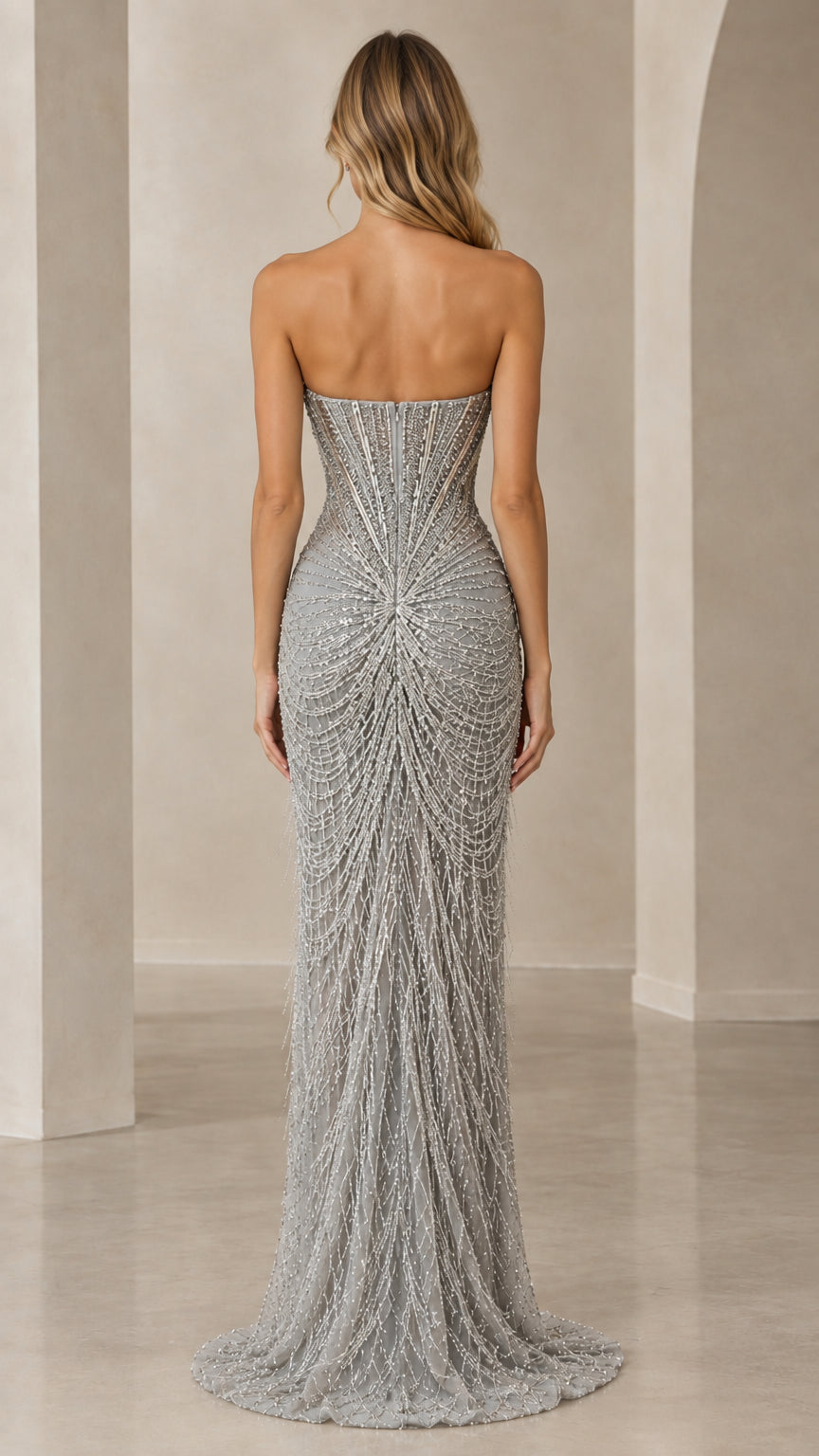 Back view of model showing the corset boning and sweeping beaded skirt