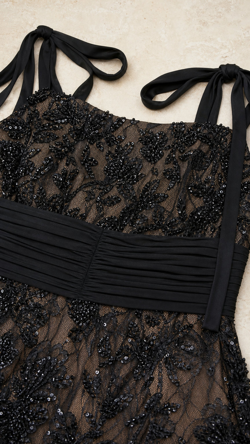 Close-up detail of black sequined lace embroidery and pleated satin waistband