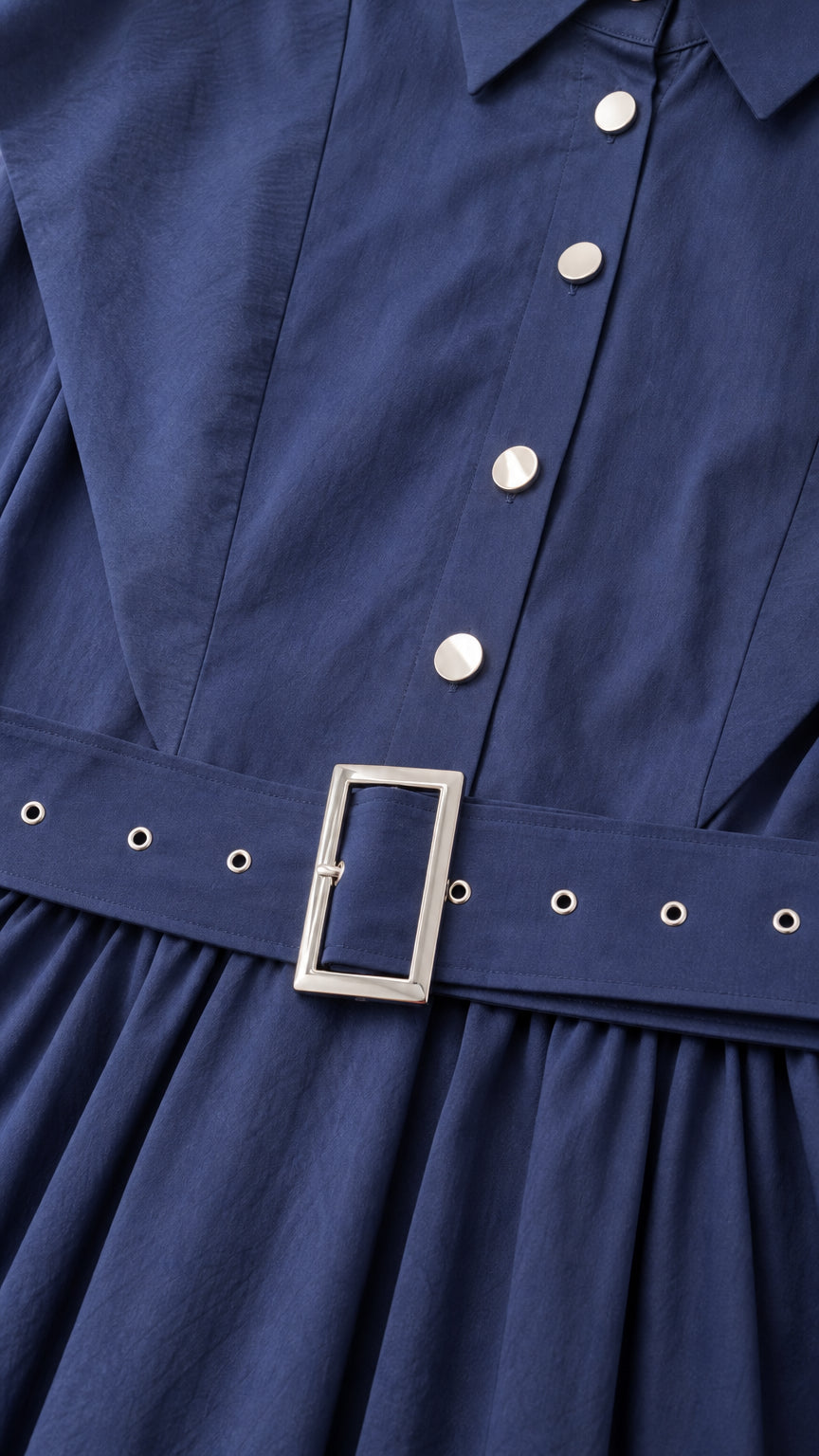 Close-up detail of navy blue dress bodice, buttons, and grommet eyelet belt