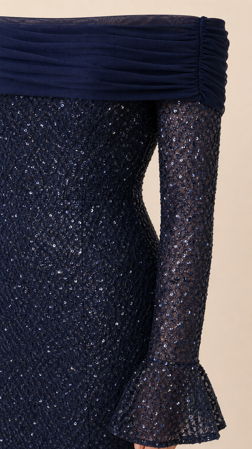 Close-up detail of navy blue ruched tulle off-shoulder neckline and sequined bell cuff