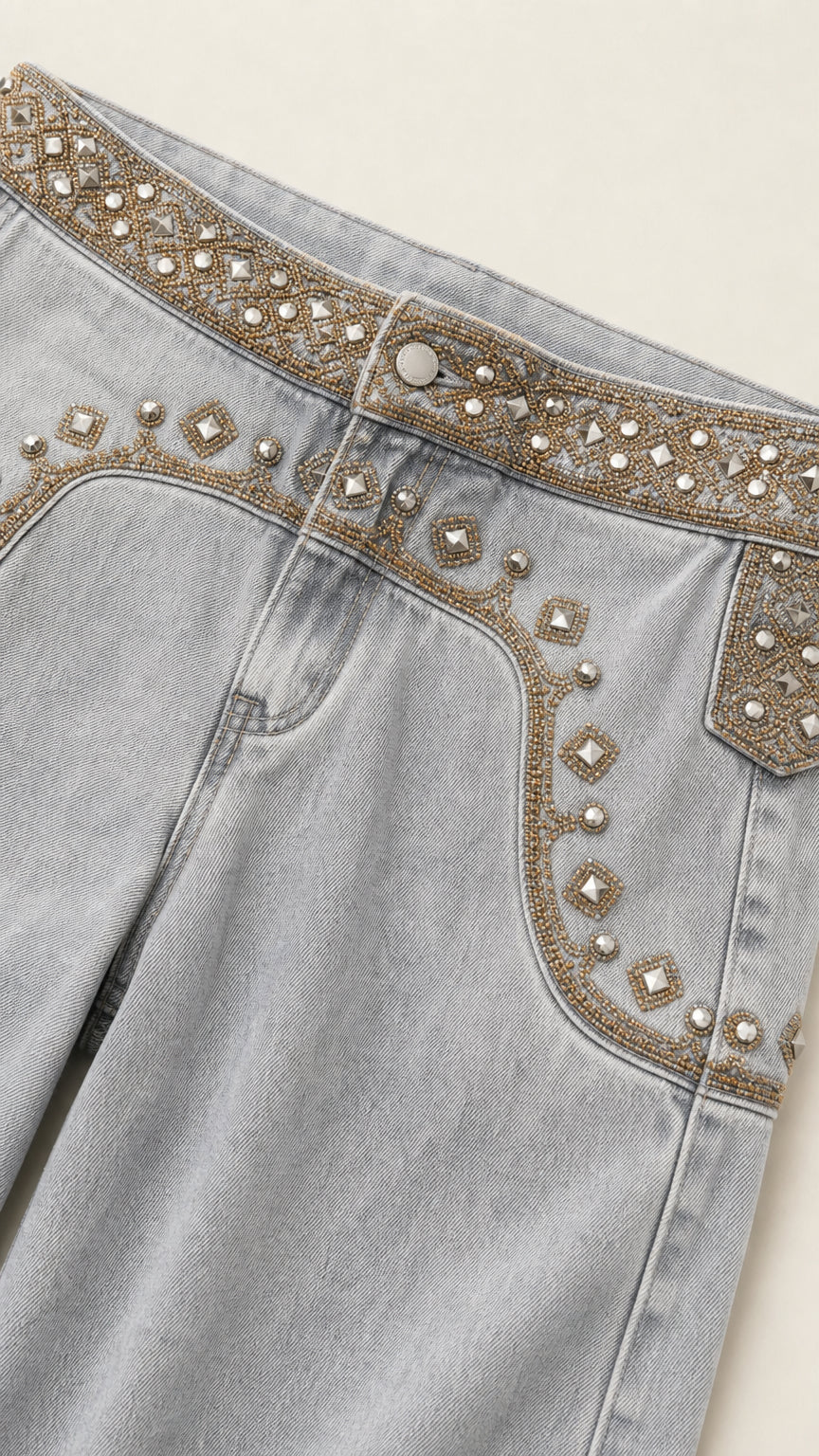 Close-up detail of metallic bead and rhinestone waistband embroidery