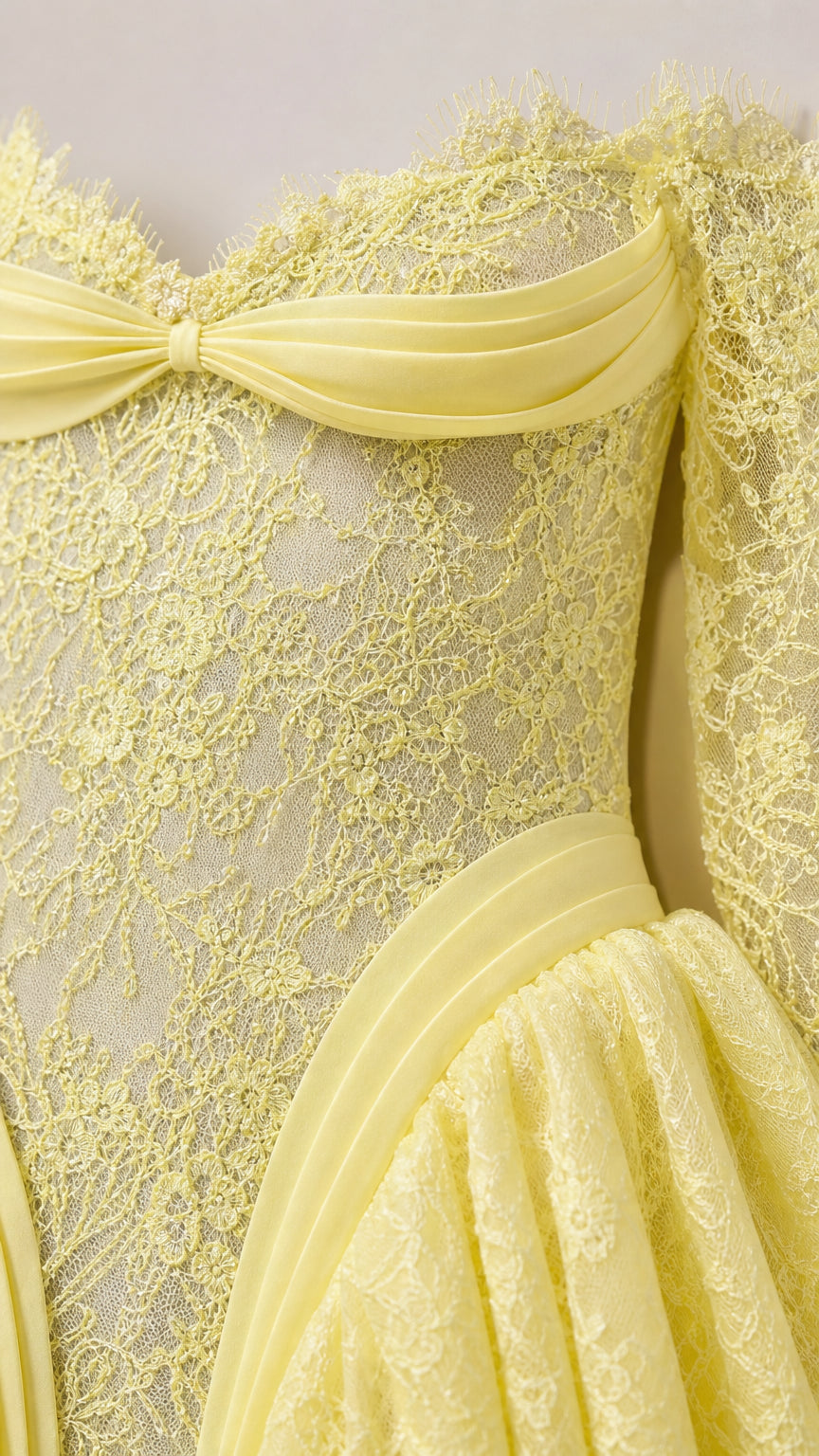 Close-up of textured lace fabric and bodice drape