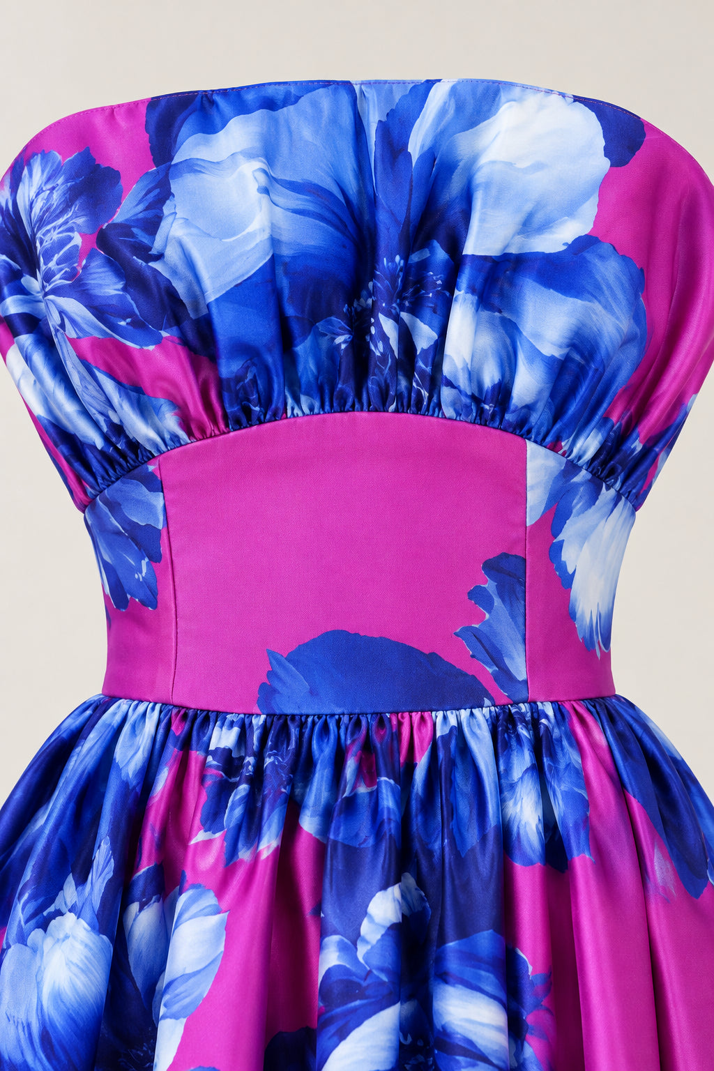 Close-up of gathered bust and inset waist detail on magenta floral dress