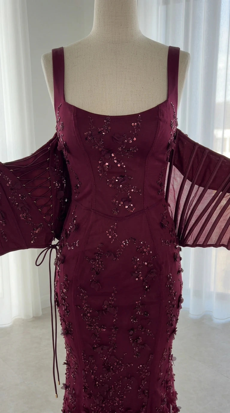 Mannequin close-up showing sequin floral details and lace-up back features