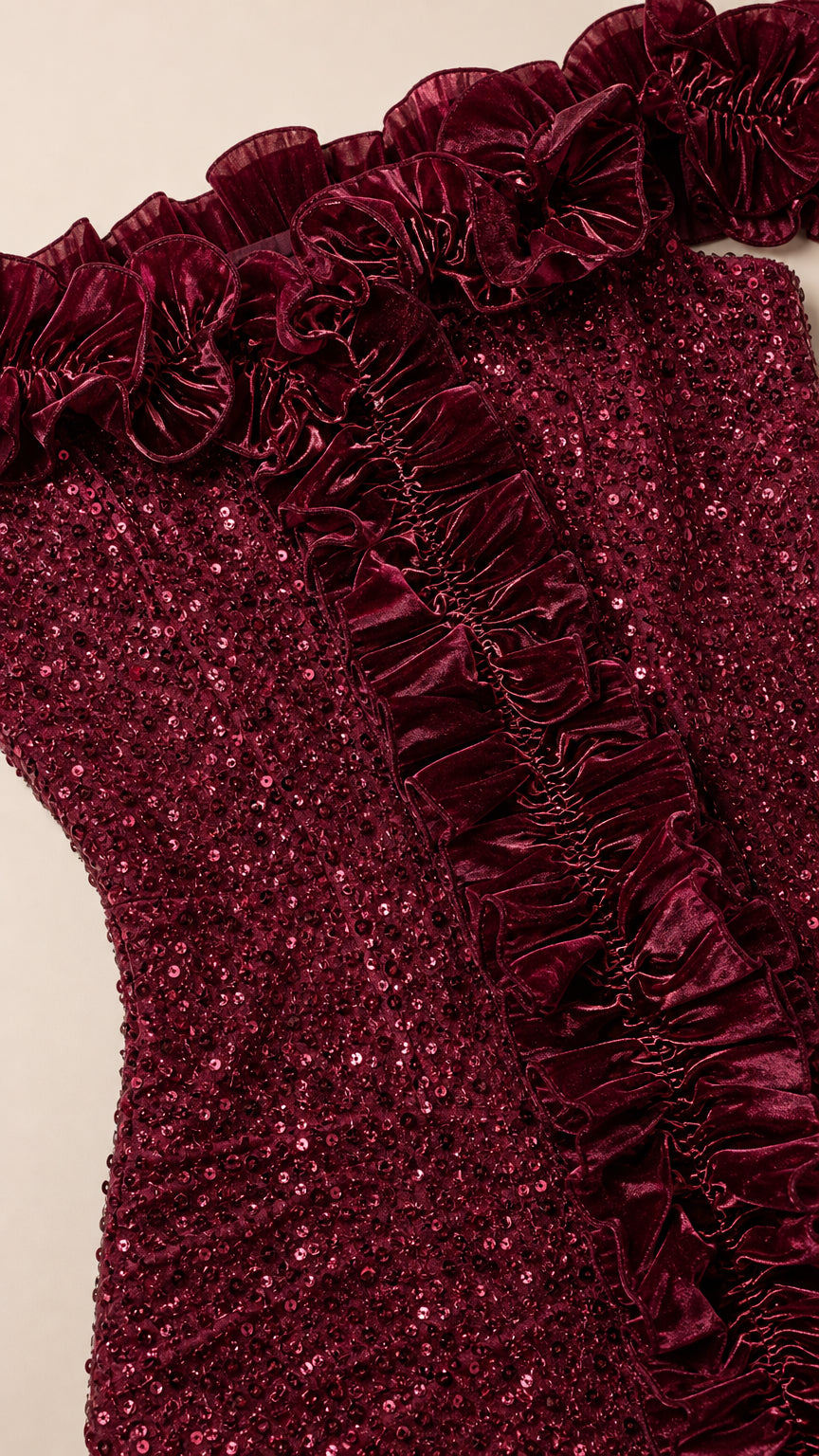 Close up detail of burgundy sequin fabric and pleated ruffle trim