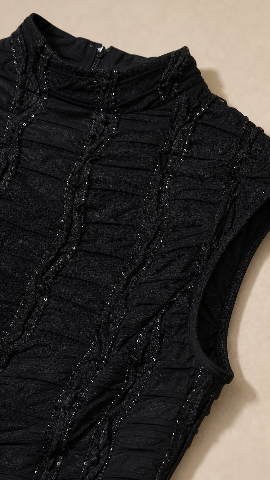 Close-up detail of textured ruching and delicate bead embellishments on bodice